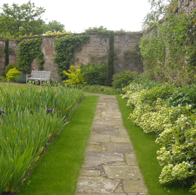 Walled garden with path leading to bench